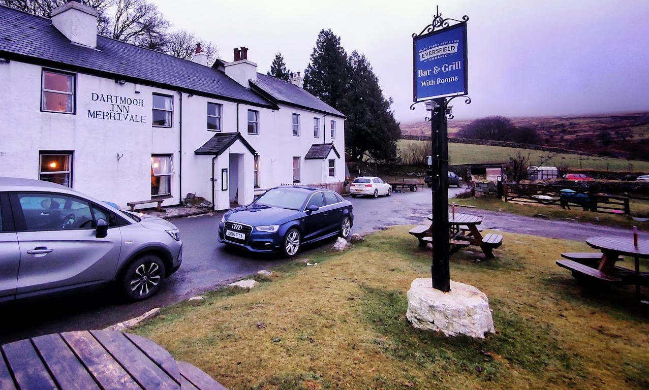 An exterior shot of a Dartmoor pub with whitewashed walls in the mist