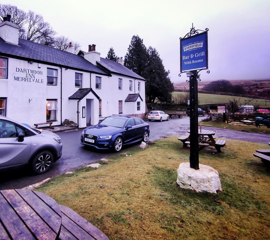 An exterior shot of a Dartmoor pub with whitewashed walls in the mist